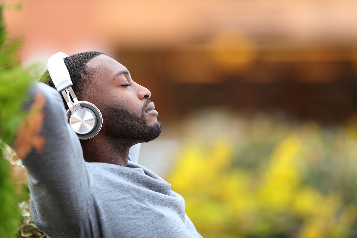Side View Portrait Of A Man With Black Skin Relaxing Listening T