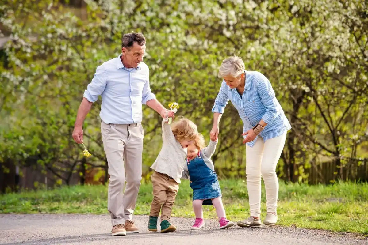 Family enjoying outdoor walk, highlighting hearing aid use in seasonal weather.